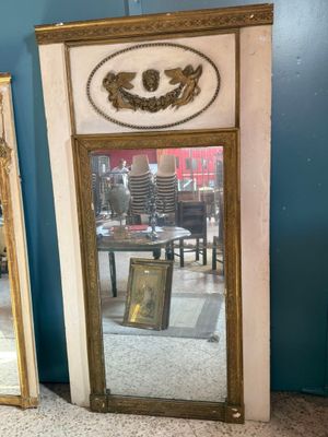 two mirrors sitting next to each other in a room