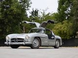 a silver mercedes 300sl is parked in a parking lot