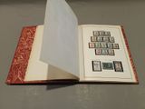 an open book with stamps on it sitting on a table