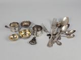 a lot of silverware on a table with spoons and forks