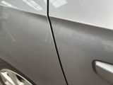 a silver car that has been painted silver and has a black sticker on it