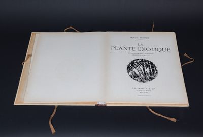 an open book sitting on top of a table on a black surface