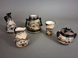 five pieces of pottery that are sitting on a table