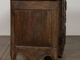 an old wooden chest of drawers on a parquet floor
