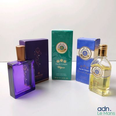 four bottles of perfume sitting next to each other on a table