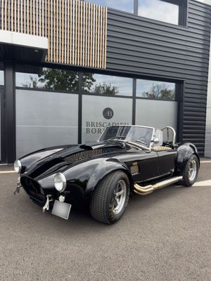 a black sports car parked in front of a building