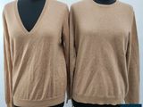two women ' s sweaters on a mannequin display
