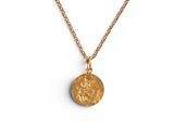 a gold necklace with a coin on a chain