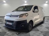 the white van is parked on a checkered floor in a room