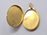 a gold locke with a picture inside of it