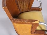 a wooden chair with a yellow seat and a metal handle