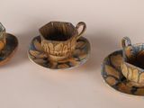three cups and saucers sitting on a table