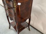 a small wooden table with a drawer on top of it