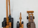two toy vehicles that are sitting next to each other