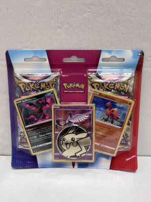 three packs of pokemon trading cards are in a package