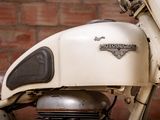 a close up of a motorcycle with a brick wall in the background