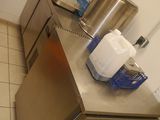 a stainless steel counter in a kitchen with pots and pans on it