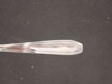 a plastic spoon with a plastic handle on a table