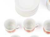 a lot of cups and saucers that are sitting on the table