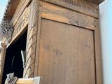 a wooden cabinet with a mirror on top of it