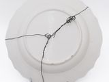 a white plate with a wire on top of it