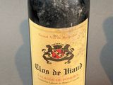 a bottle of wine sitting on a table next to a bottle of wine
