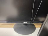 a computer monitor sitting on top of a desk