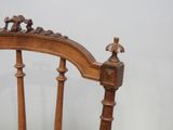 a wooden chair with a carved back and a wooden seat