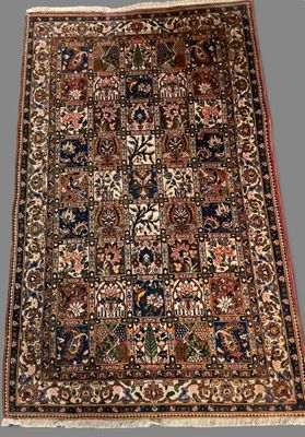 an antique persian rug with a floral design