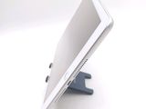 a tablet computer sitting on a stand on a white surface
