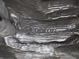a close up of a bronze statue of a dog