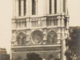 people standing in front of a large cathedral with a clock on it ' s side