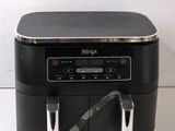 an image of a black and silver radio on a white surface