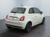 the back of a white fiat car parked in a white room