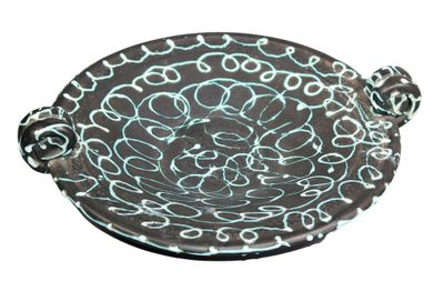 an image of a decorative bowl with a handle