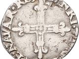 a close up of a coin with a cross on it