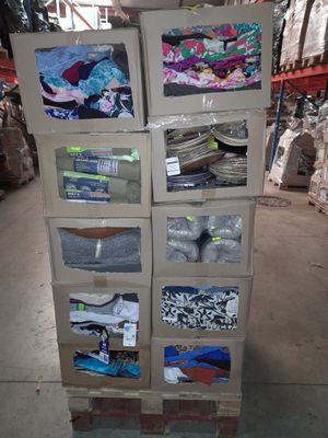 boxes of clothing are stacked on top of each other in a warehouse
