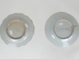 two plates that are sitting on a white table