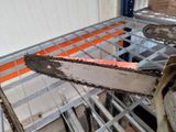a chainsaw that is sitting on a shelf in a room