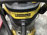a yellow and black vacuum on the floor in the garage