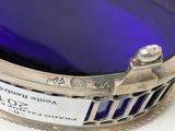 a blue glass bowl sitting on top of a white table