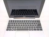 a silver laptop with a black keyboard on a white table