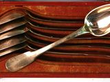 spoons and spoon rest in a red case with a white background