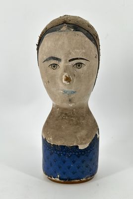 a ceramic doll of a woman with a headband