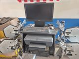 an image of a computer desk with a monitor and printer