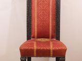a red and black chair that is on a wooden floor