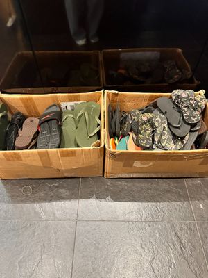 two boxes of shoes that are sitting on the floor