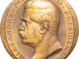 an image of a gold medal with a man ' s face on it