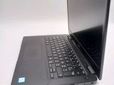 a laptop that is open on a white table