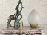 a statue of a horse and an egg on a table